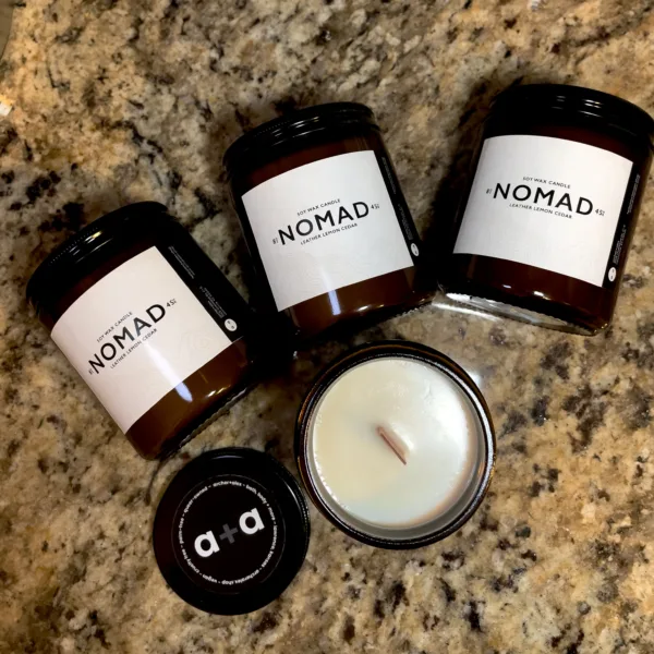 Nomad woodwick candle by archer+alex featuring notes of leather, lemon and cedar.