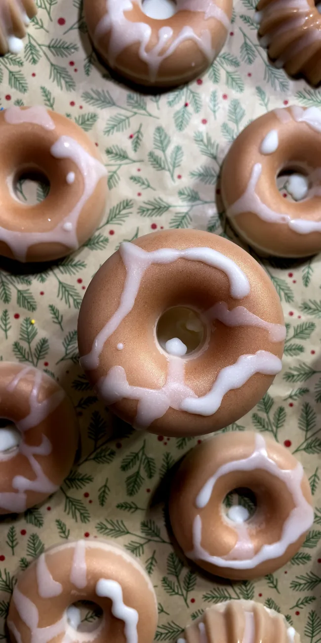 Cinnamon Bun wax melt donuts by archer+alex on a festive fir tree background